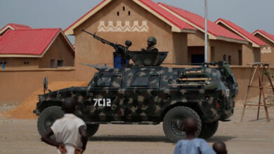An armored vehicle of Nigerian Security Forces drives by newly built homes which were destroyed by Boko Haram armed militants in 2015 in Ngarannam, Borno State, Nigeria on October 21, 2022. REUTERS/Christophe Van Der Perre